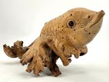a wooden sculpture of a fish on a white background