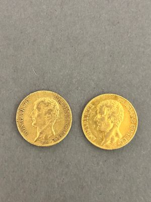 two gold sovereigns, one with the head of a man and one with a woman