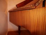 a piano that is sitting on top of a wooden table