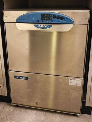 a silver and blue dishwasher in the corner of a kitchen