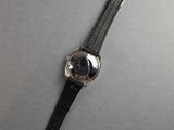 a close up of a watch sitting on top of a table