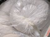 a large bag of doughnuts wrapped in plastic