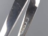 a close up of a spoon with a silver handle on a table