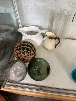 many different colored vases on a shelf next to each other