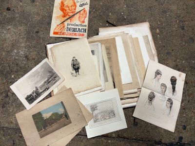 a pile of old books on the ground with pictures on them