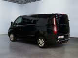 a picture of a black van parked in a large room