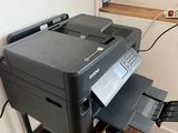 a printer sitting on top of a cart in a room