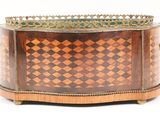 a small wooden box with a checkered pattern on it