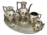 a silver tray with a silver tea set on it