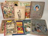 several old children ' s books are lined up on a white surface