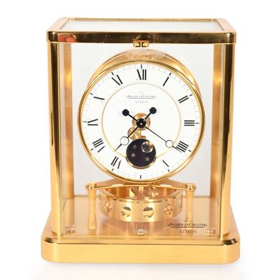 gold plated clock with glass case and roman numerals