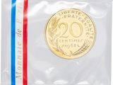 a coin in a plastic bag with a red, white and blue ribbon