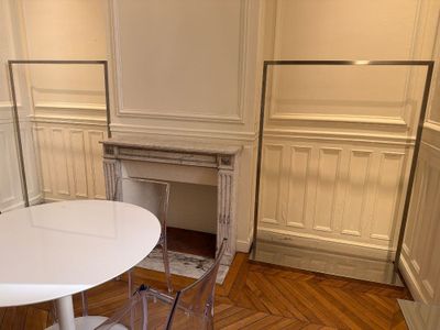 une table et des chaises blanches dans une pièce avec une cheminée