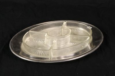 a silver tray with a candle on it on a black background