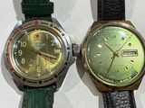 two watches sitting next to each other on a table