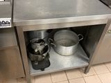 a stainless steel counter with pots and pans on it