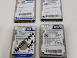 three hard drives sitting on top of a white table next to each other
