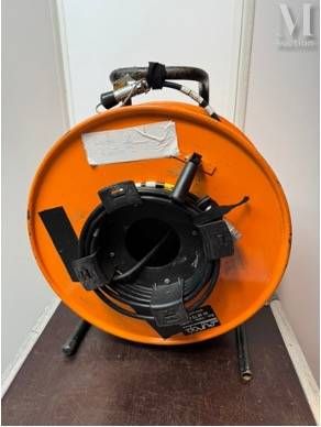 a large orange blower sitting on a wooden floor