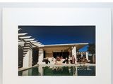 an image of a picture of a hotel with a pool in front of it