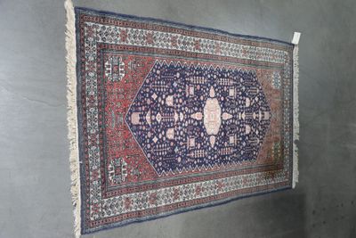 rug hanging on a wall in a room with a wall hanging on the wall