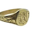 an image of a gold signet ring with a coat of arms on it