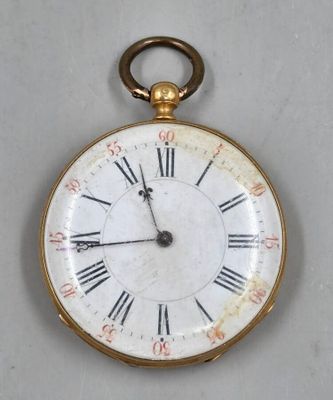a gold pocket watch with roman numerals on the face