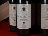 three bottles of wine sitting on a red table