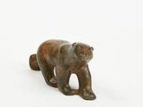 a small statue of a bear on a white surface