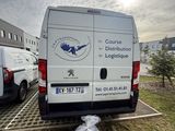 a van parked in a parking lot with bags of food in front of it