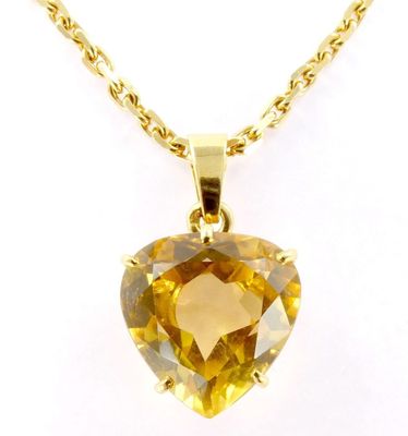 a close up of a necklace with a heart shaped citrine