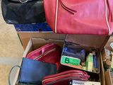 a box full of purses and other items on the floor