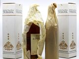three bottles of wine wrapped in brown paper sitting next to each other