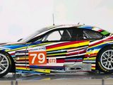 painting of a colorful car on display on a white surface