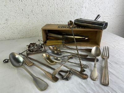 a lot of silverware in a wooden box on a table