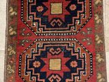 an old rug with two different colors and designs on it