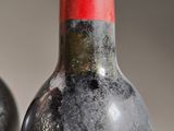 two bottles of wine sitting next to each other on a table