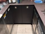 a small outdoor kitchen with a sink and a stove