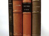 four books that are stacked on top of each other