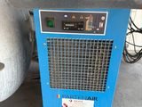 a close up of a blue air dryer sitting on top of a cement floor