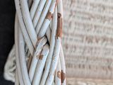 a close up of a wicker chair with a knot on the back