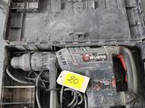 a box with a drill and other tools on the floor