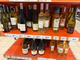 many bottles of wine on the shelves in the store