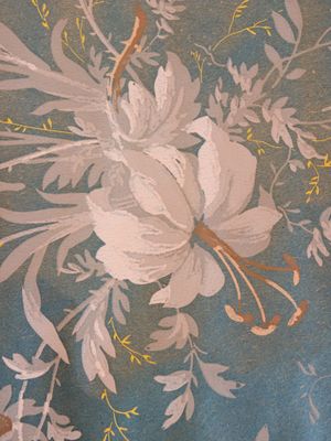 a close up of a painting of flowers on a wall