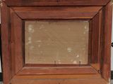 an old picture frame sitting on top of a piece of wood