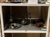 a cabinet with pots and pans on top of it