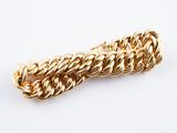 a close up of a gold chain bracelet on a white background