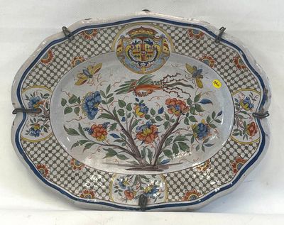 une assiette décorative ornée d'un motif représentant un oiseau et des fleurs