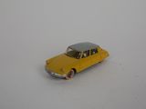 yellow toy car on a white surface with a white background