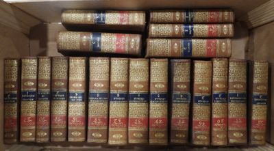 many old books in a box on the shelf