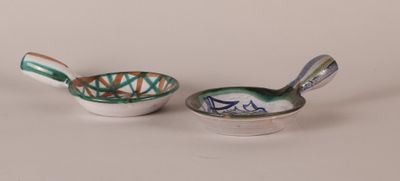 two bowls and spoons sitting next to each other on a table